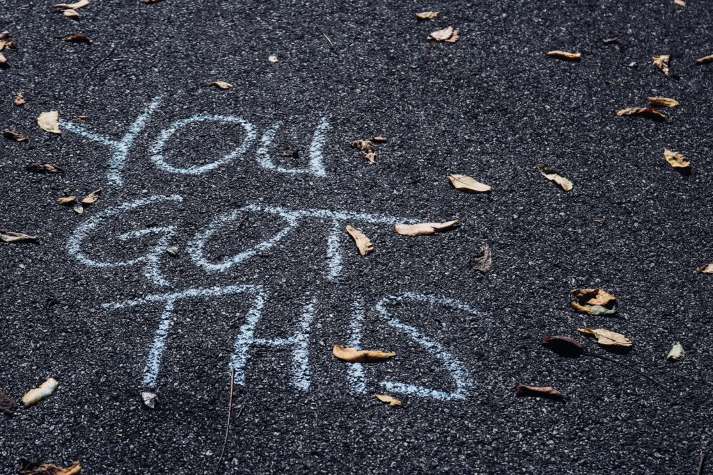 Chalk writing on asphalt, reading 