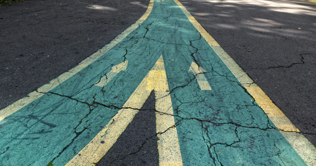 Image of two bike lanes merging, integrating, into one.