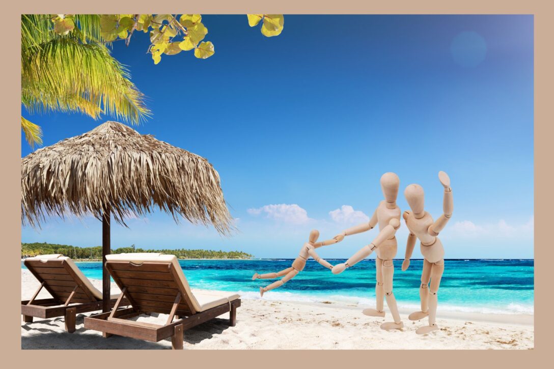 Wooden figures on a beach as a family